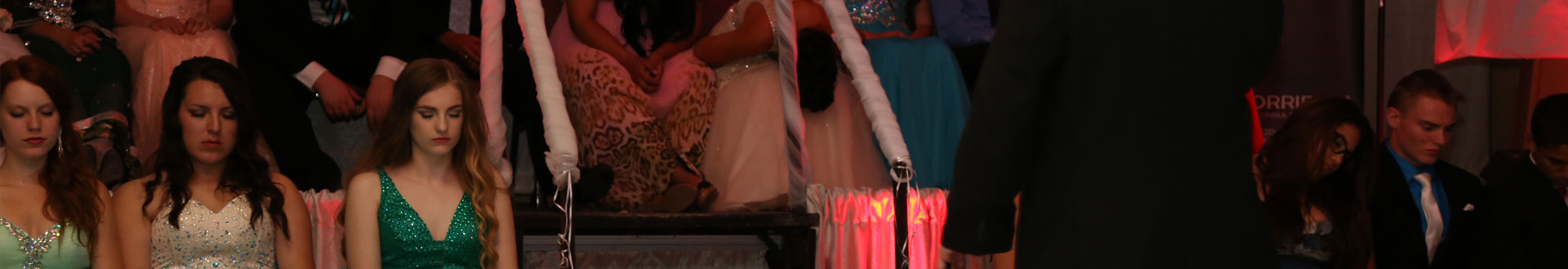 Aftergrad students sitting with their eyes closed on stage